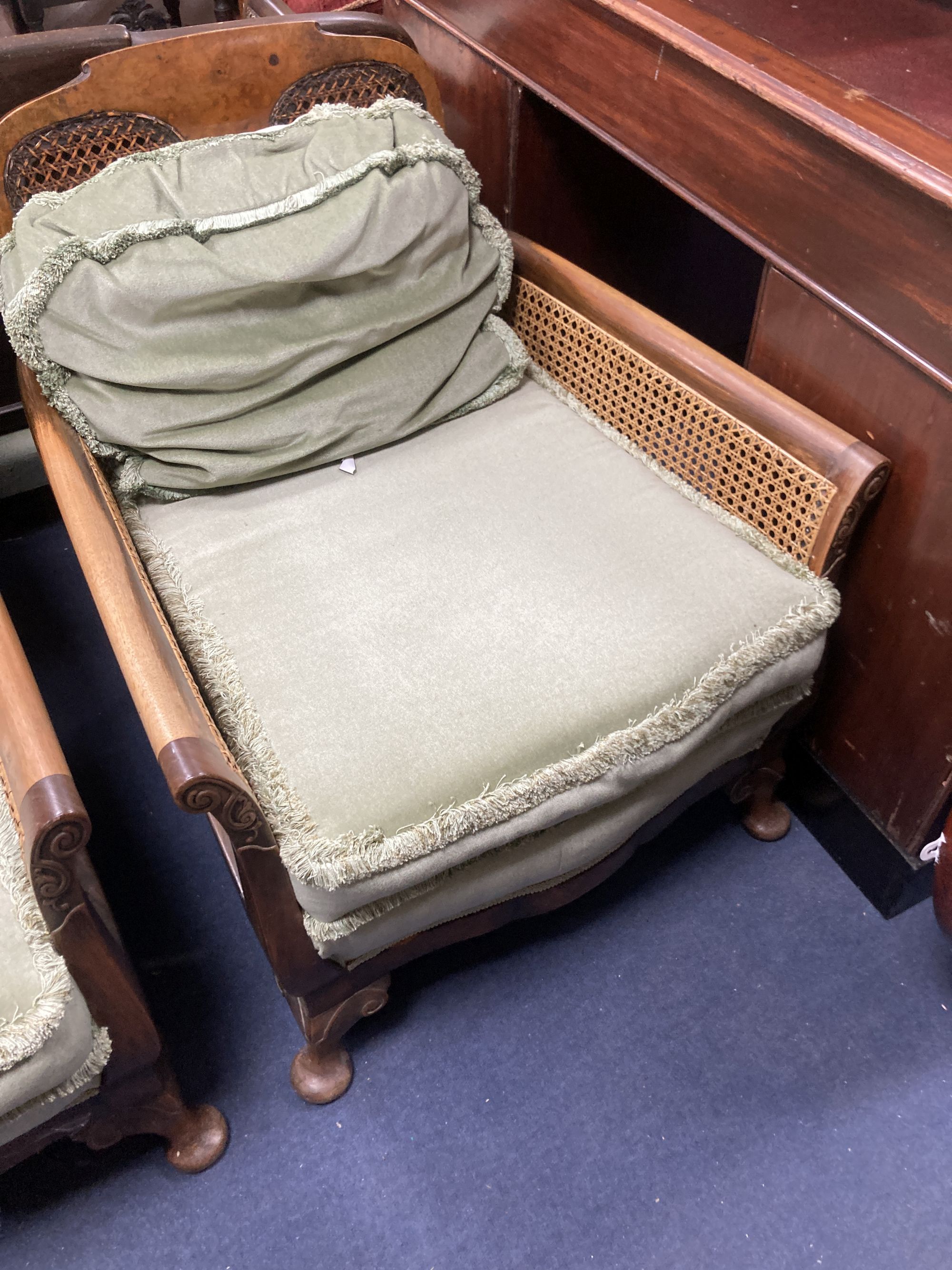 A 1920s mahogany framed three piece Bergere suite, together with a stool